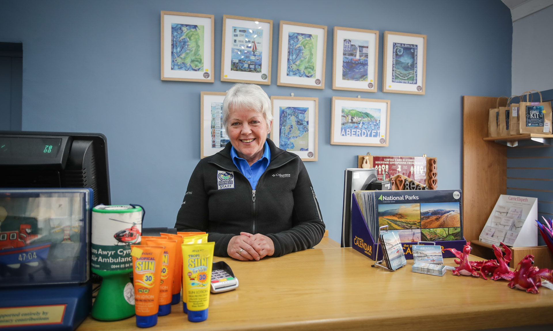 National Park Information Centre staff member smiling in the reception in Aberdyfi