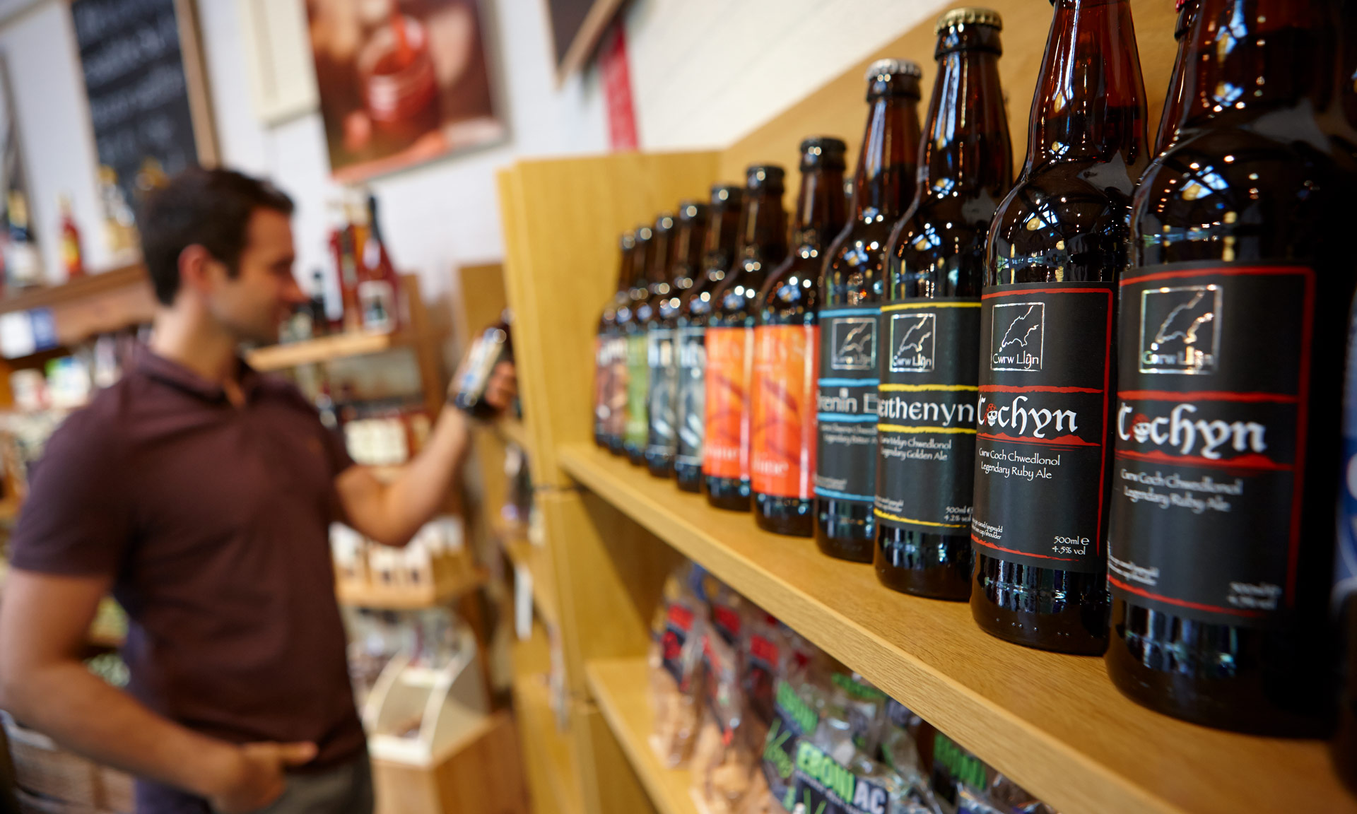 Local ales lined up on a shop shelf in one of our tourist information centre