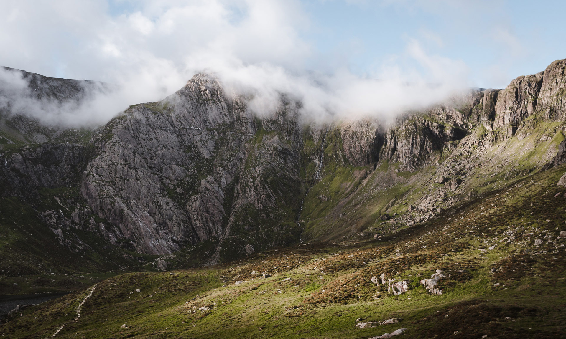 Cwm Idwal with clouds forming above with some blue sky