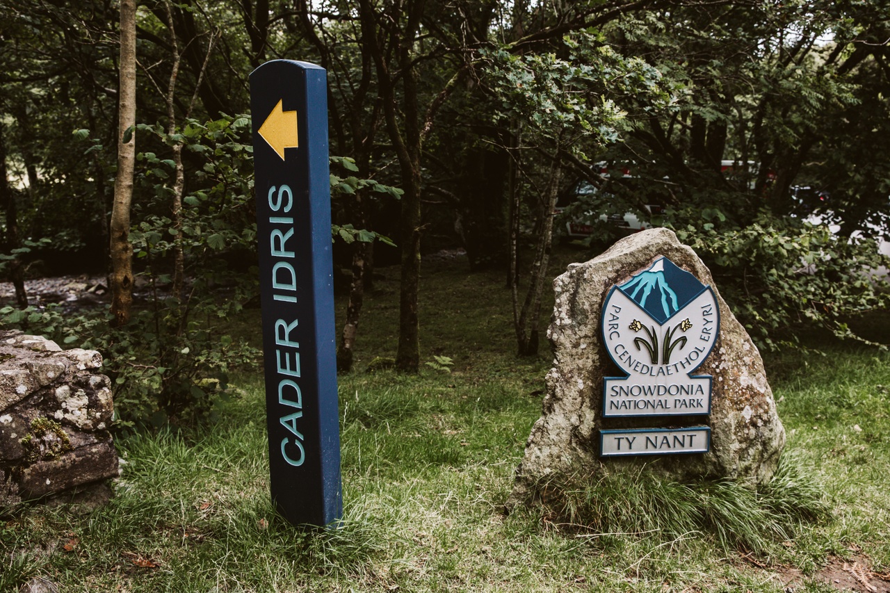 Cader Idris sign stands along Eryri National Park emblem