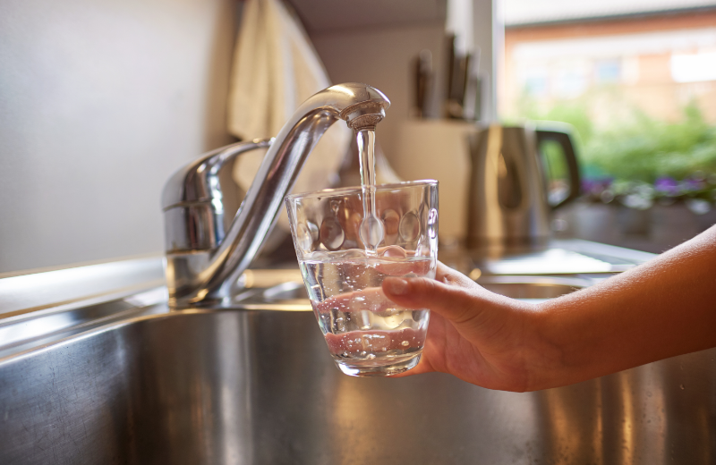 a glass under a tap of running water