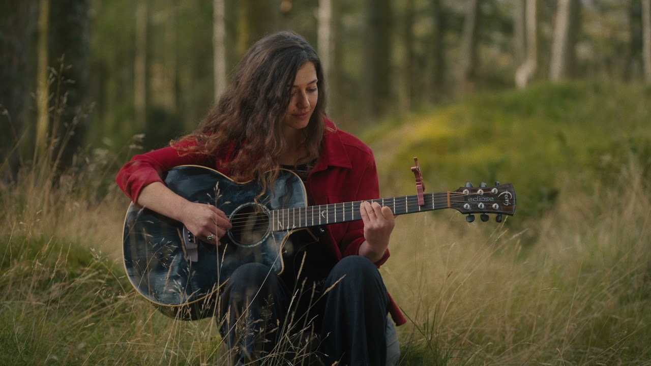 Eve Goodman playing guitar