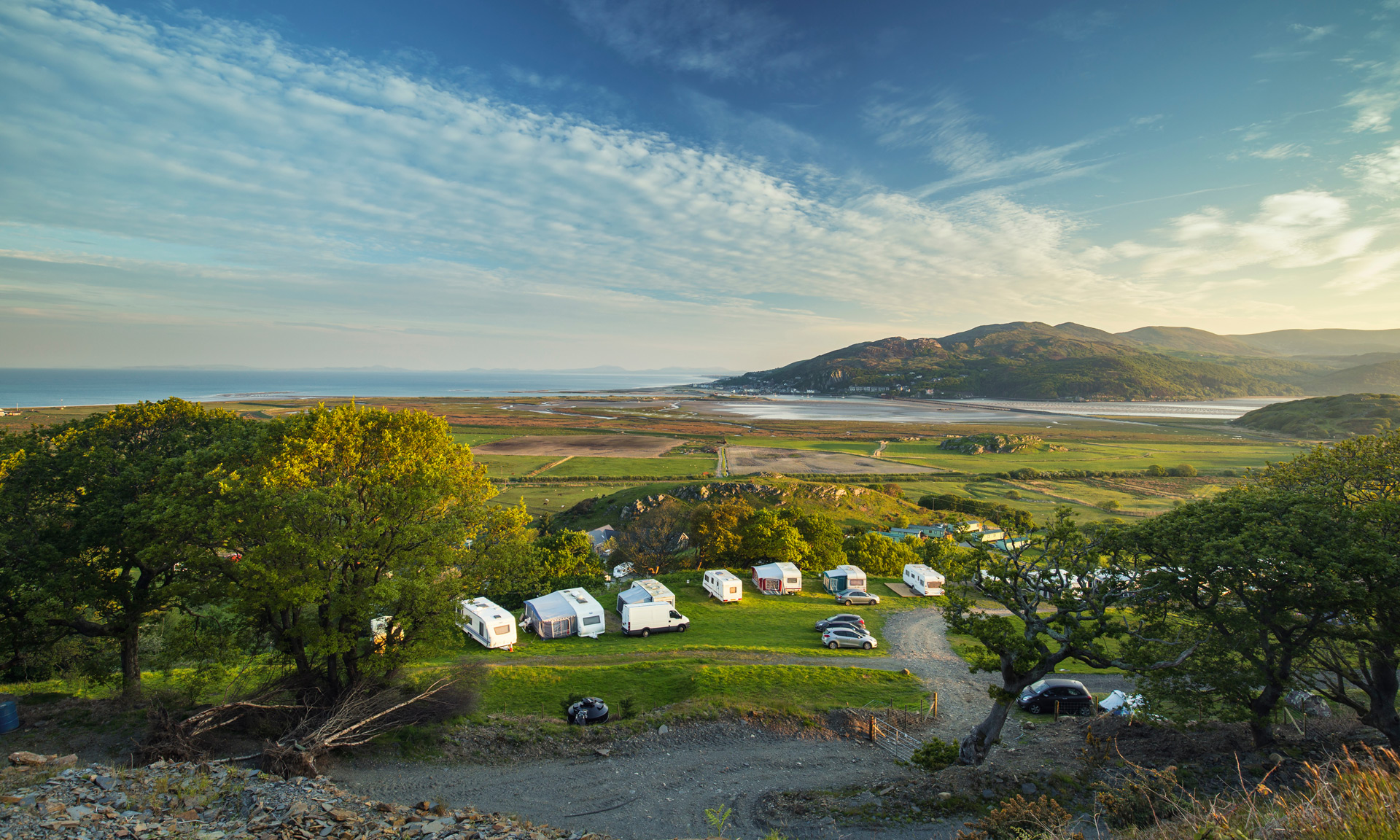 View of Mawddach estuary with campervans and caravans in the foreground