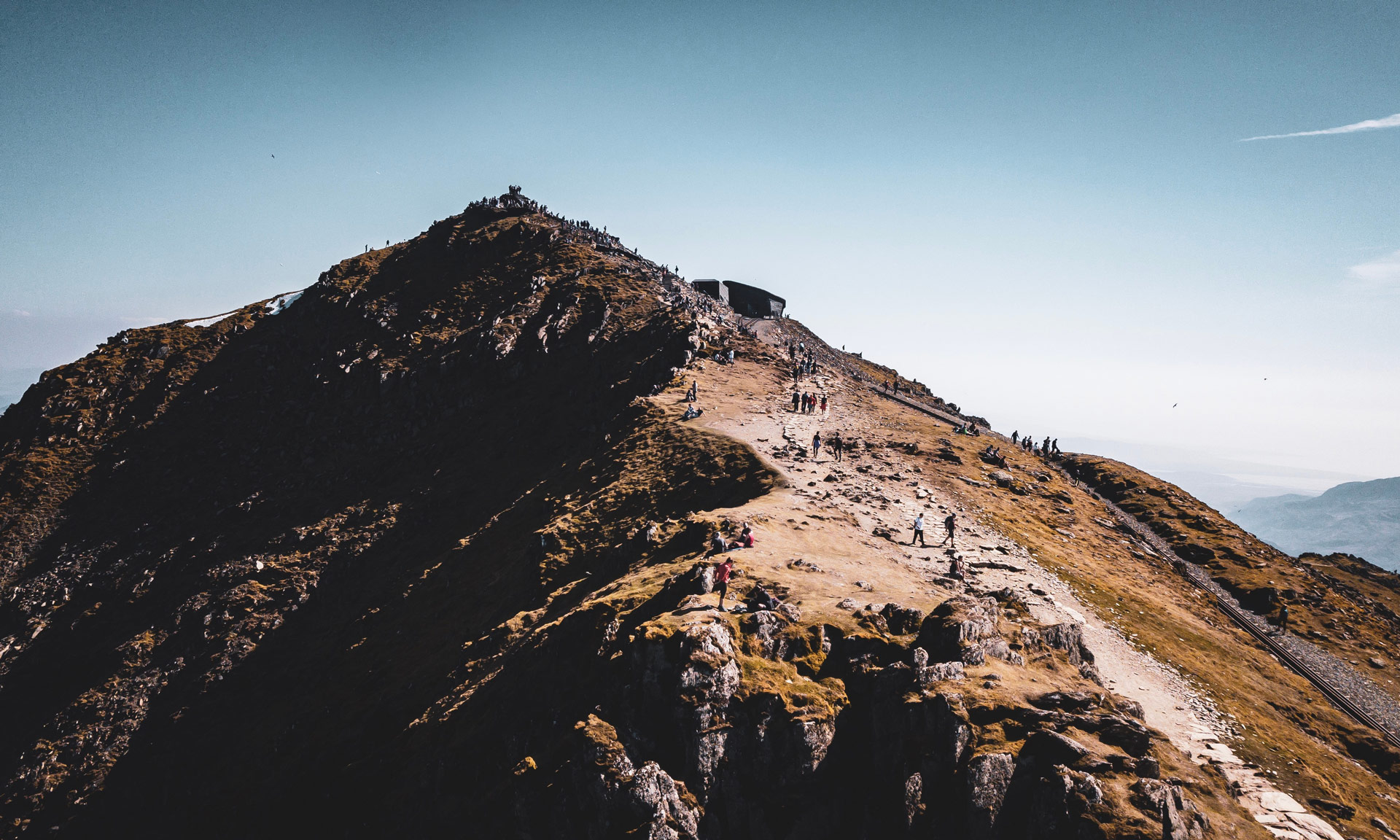 Drone photo of Yr Wyddfa's summit busy with hikers on a summer's day