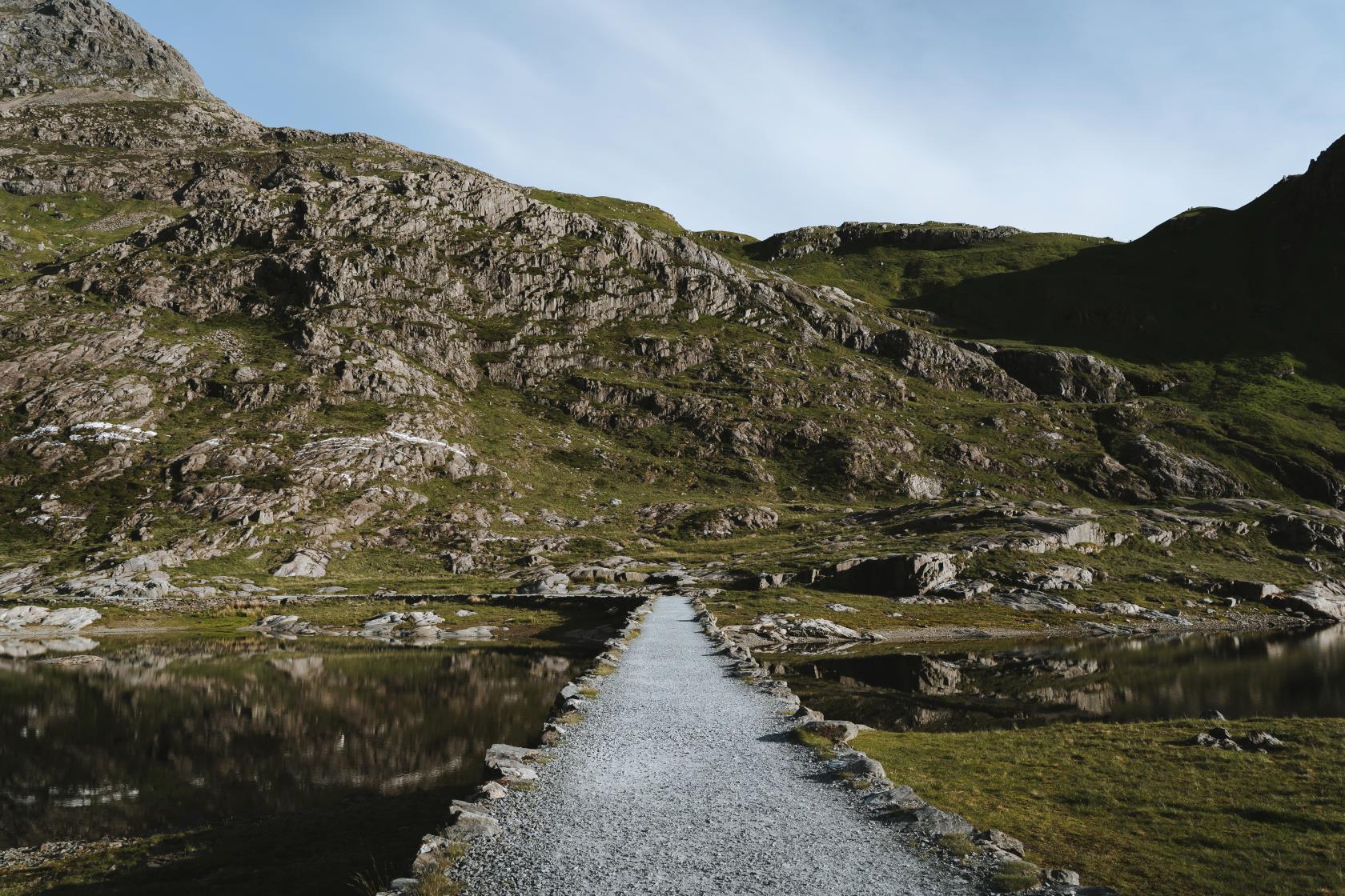 Llyn Llydaw causeway streches over the lake on a srping day.