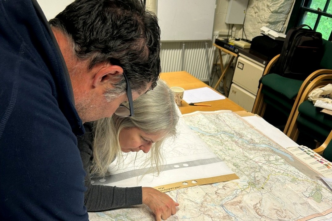 People looking at place names on a map